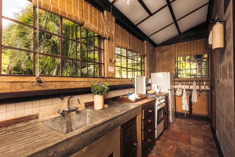 The fully equipped kitchen with a stone sink, gas cooker and fridge