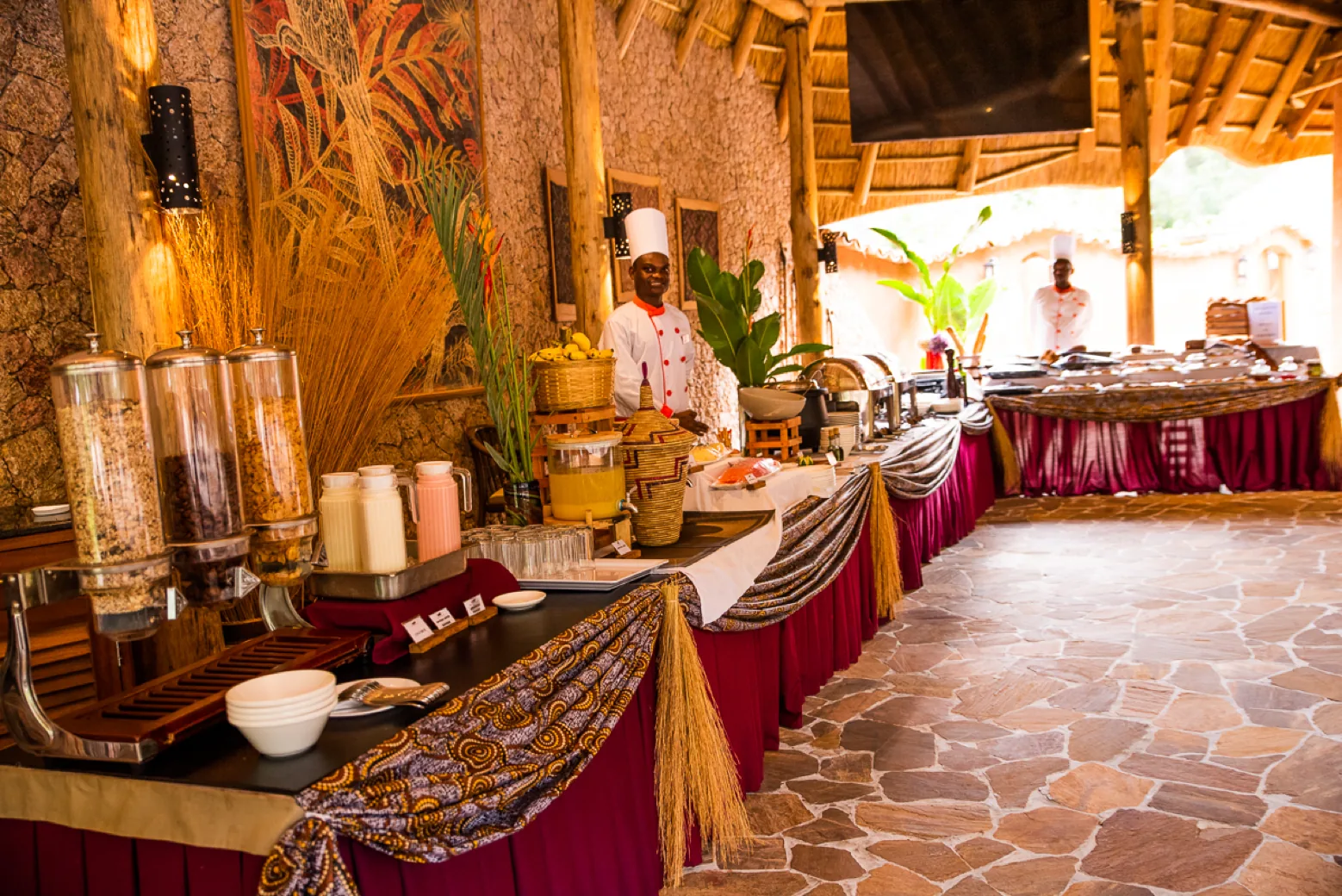 Chefs standing behind a breakfast buffet of cereals, juice, fruit and hot dishes